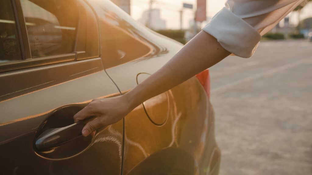 a person opening a car door