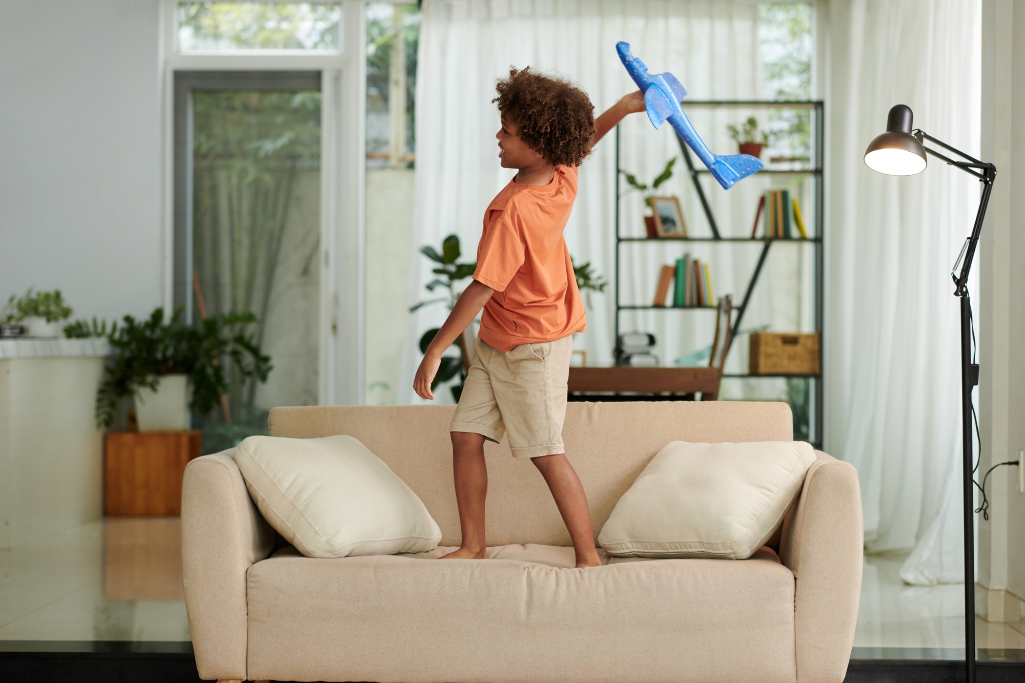 Boy Playing with Toy Plane