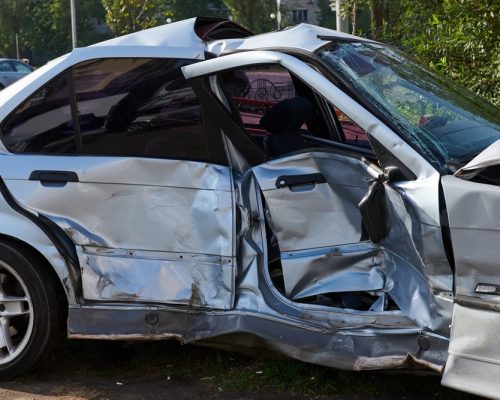 silver car smashed in a side-impact accident